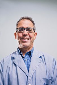 Kalamazoo Anesthesiology headshot of doctor with glasses smiling